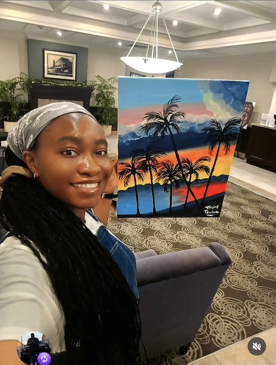 Tosin holding an original sunset painting